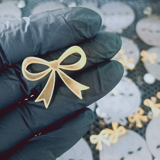 Apliqué acrílico lazo dorado - 100 un