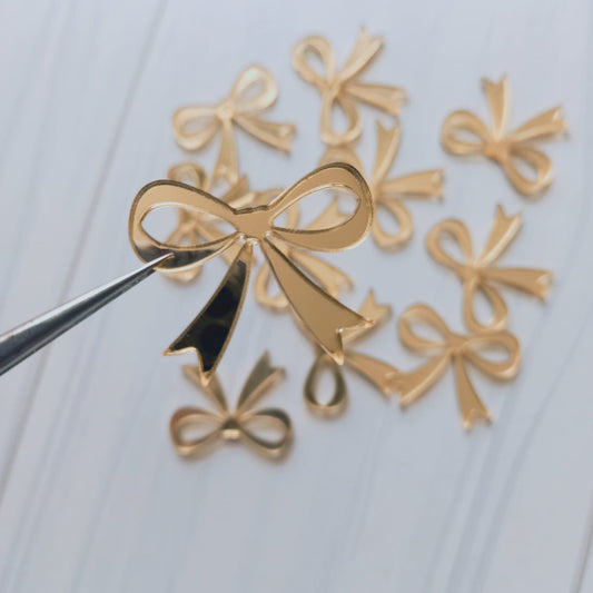 Apliqué acrílico lazo dorado - 10 un