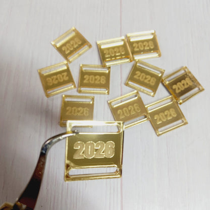 Dije Acrílico espejo dorado 2026 para medallas 100un